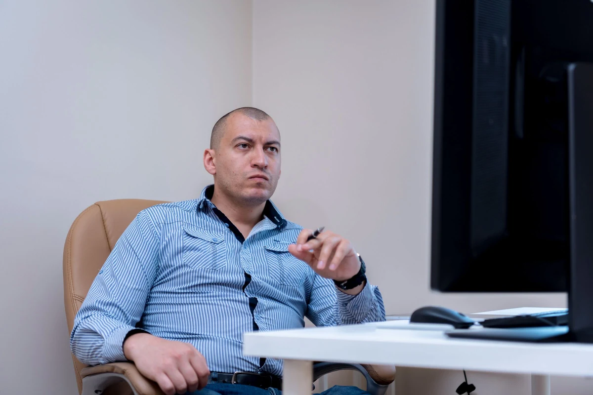 Responsable comercial pensativo frente al monitor de su oficina, decidiendo qué hacer con las oportunidades estancadas